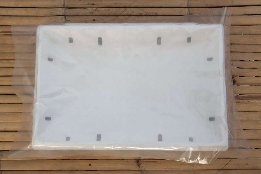 Plastic liner laid over the lower half of the grow box.