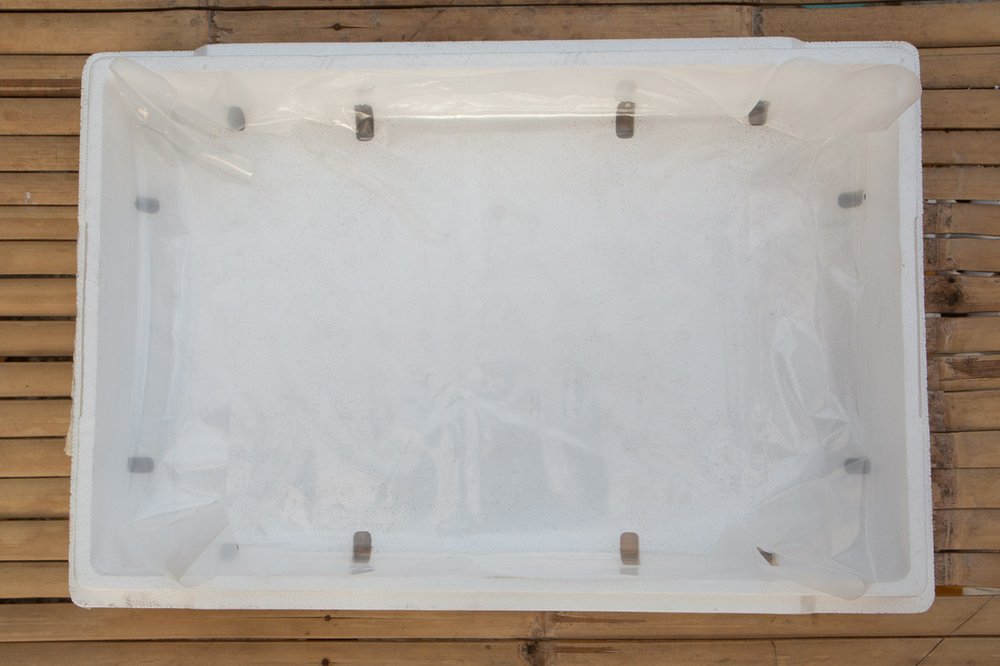 Plastic liner with ends and sides folded fitting into the lower half of
the grow box.